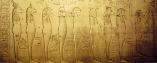 Ancient Egyptian wall carving featuring a cat